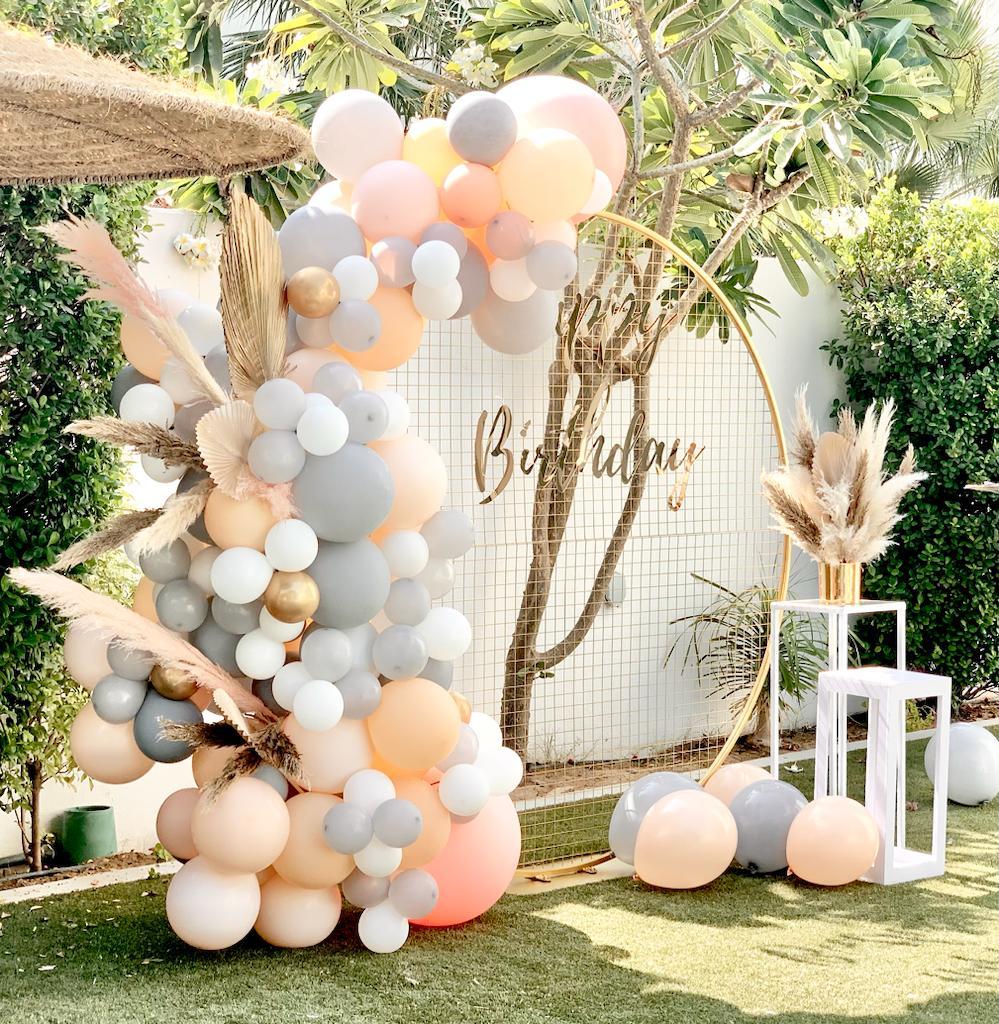 Custom balloon arch setup for birthday event in Melbourne garden